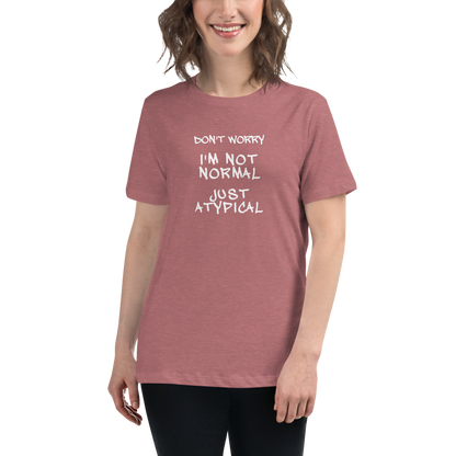 "Don't Worry I'm Not Normal Just Atypical" printed on a heather mauve women's relaxed t-shirt worn by a female