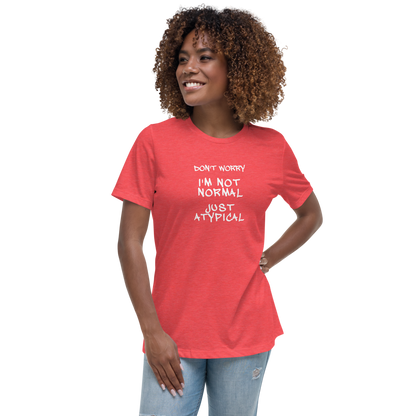"Don't Worry I'm Not Normal Just Atypical" printed on a heather red women's relaxed t-shirt worn by a female