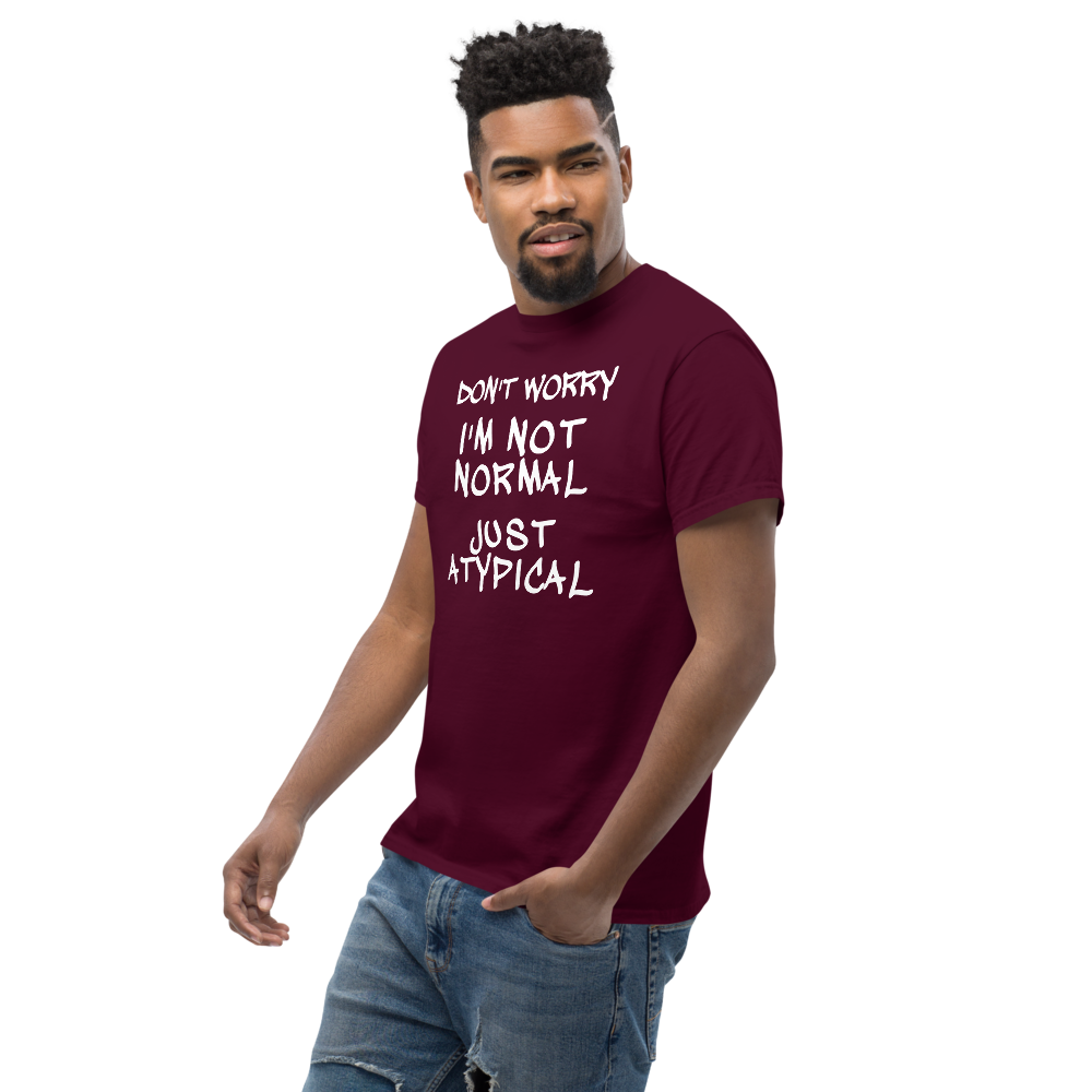 "Don't Worry I'm Not Normal Just Atypical" printed on a maroon unisex classic tee worn by a male