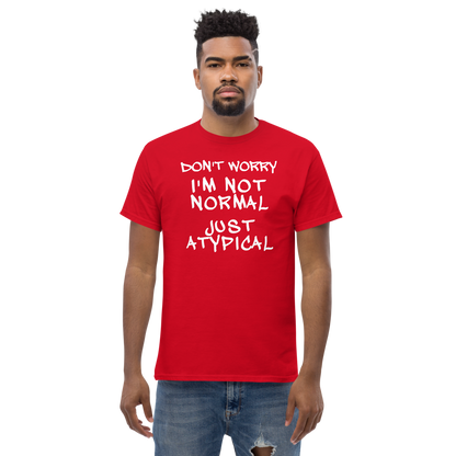 "Don't Worry I'm Not Normal Just Atypical" printed on a red unisex classic tee worn by a male