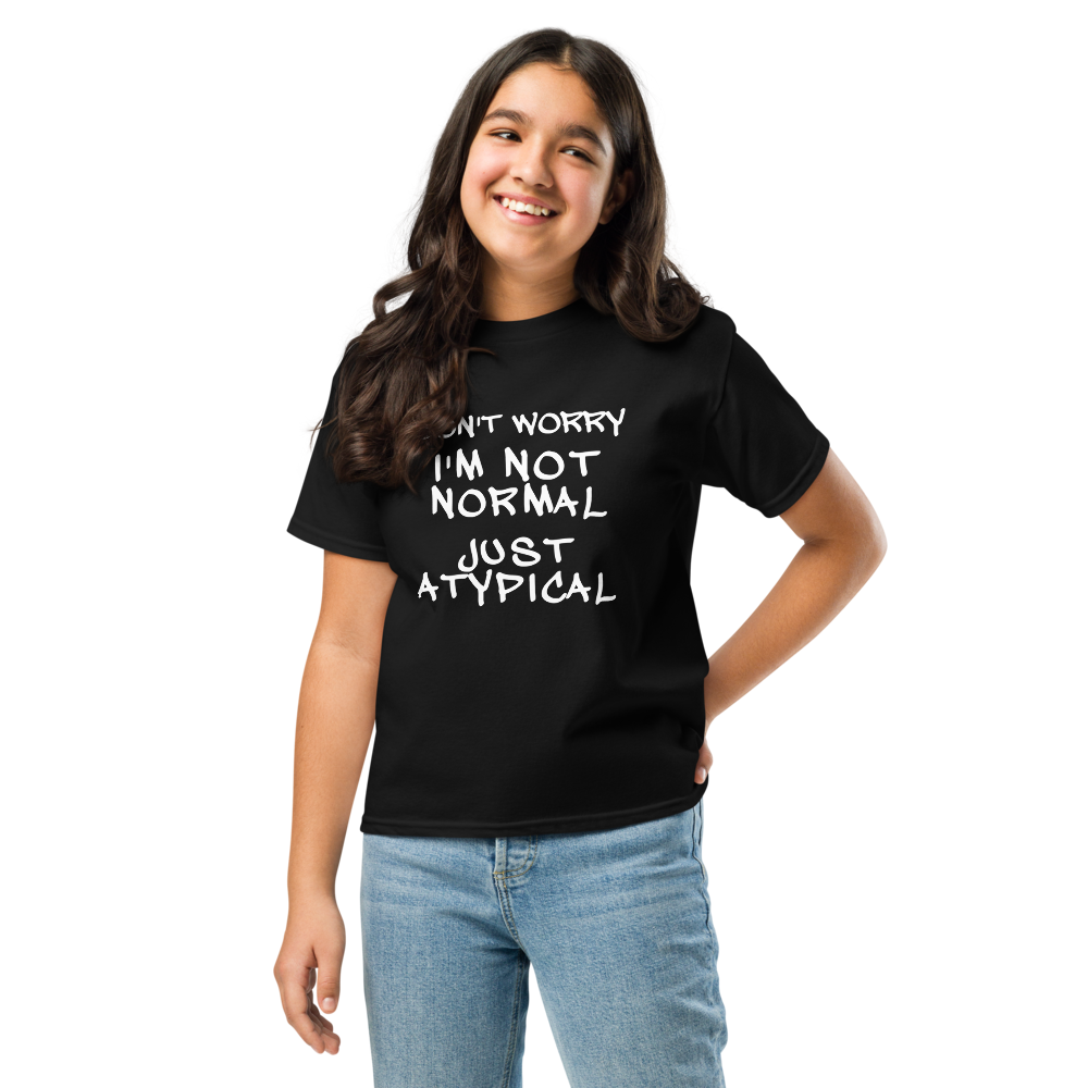 "Don't Worry I'm Not Normal Just Atypical" printed on a black youth classic tee worn by a female