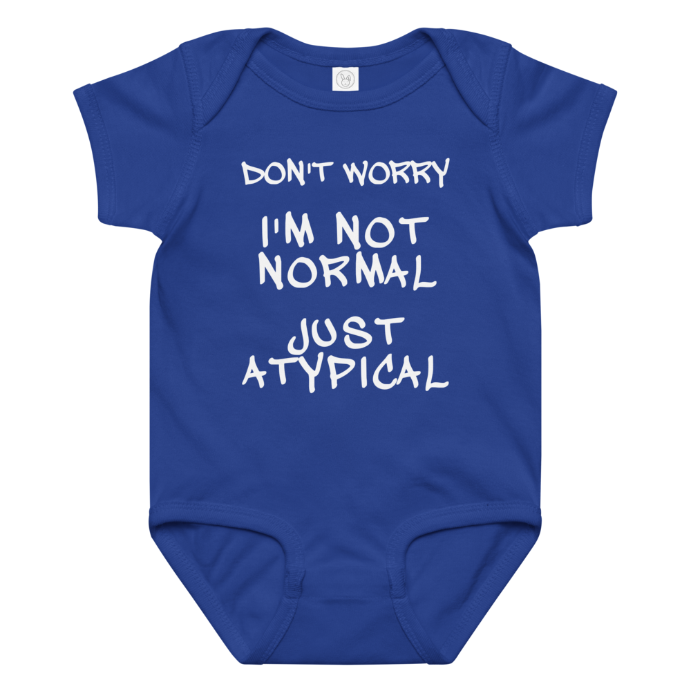 "Don't Worry I'm Not Normal Just Atypical" printed on a royal baby jersey bodysuit laying on a flat surface amongst other clothes
