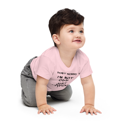 "Don't Worry I'm Not Odd Just Atypical" printed on a pink baby jersey short sleeve tee worn by a male who is crawling