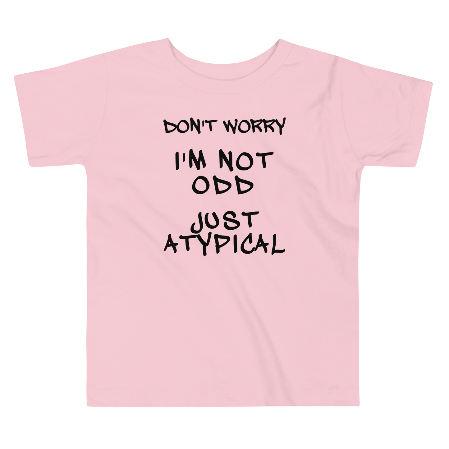 "Don't Worry I'm Not Odd Just Atypical" printed on a pink toddler short sleeve tee laying on a flat surface