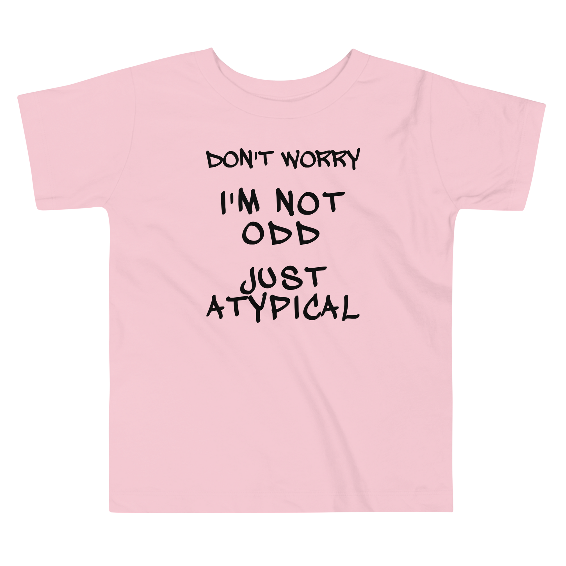 "Don't Worry I'm Not Odd Just Atypical" printed on a pink toddler short sleeve tee laying on a flat surface