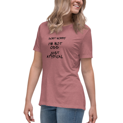 "Don't Worry I'm Not Odd Just Atypical" printed on a heather mauve women's relaxed t-shirt worn by a female