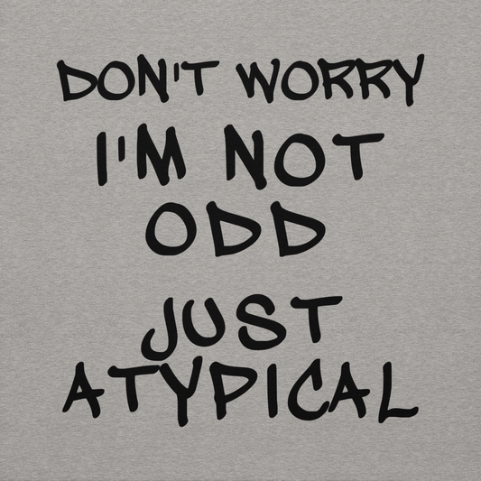 "Don't Worry I'm Not Odd Just Atypical" printed on a carbon grey background