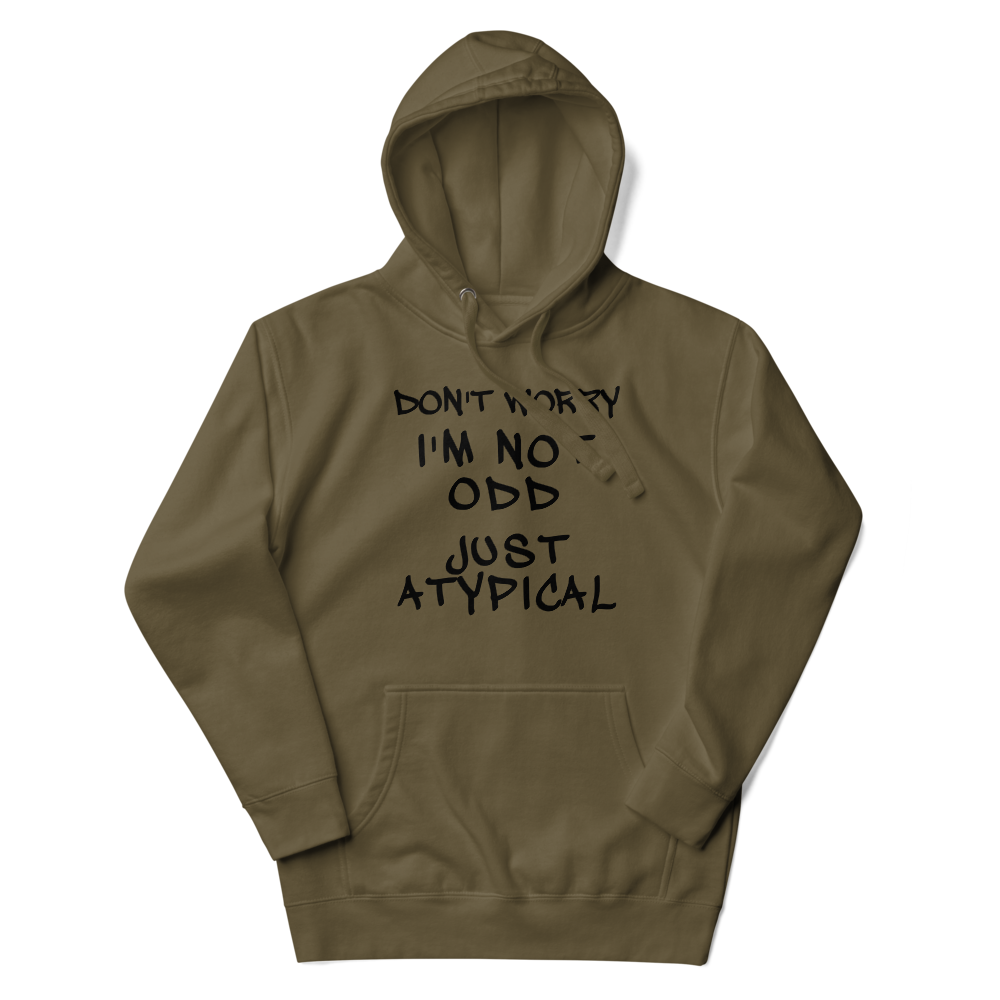 "Don't Worry I'm Not Odd Just Atypical" printed on a military green unisex hoodie laying on a flat surface with the hood up
