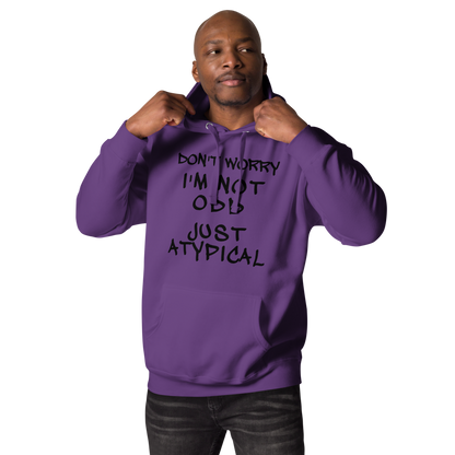 "Don't Worry I'm Not Odd Just Atypical" printed on a purple unisex hoodie worn by a male