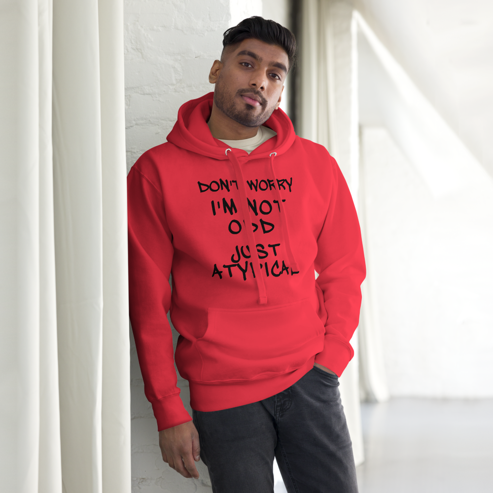 "Don't Worry I'm Not Odd Just Atypical" printed on a team red unisex hoodie worn by a male
