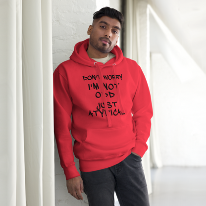 "Don't Worry I'm Not Odd Just Atypical" printed on a team red unisex hoodie worn by a male