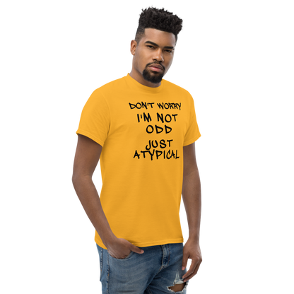 "Don't Worry I'm Not Odd Just Atypical" printed on a gold unisex classic tee worn by a male