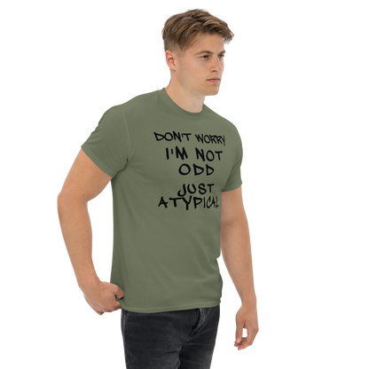 "Don't Worry I'm Not Odd Just Atypical" printed on a military green unisex classic tee worn by a male