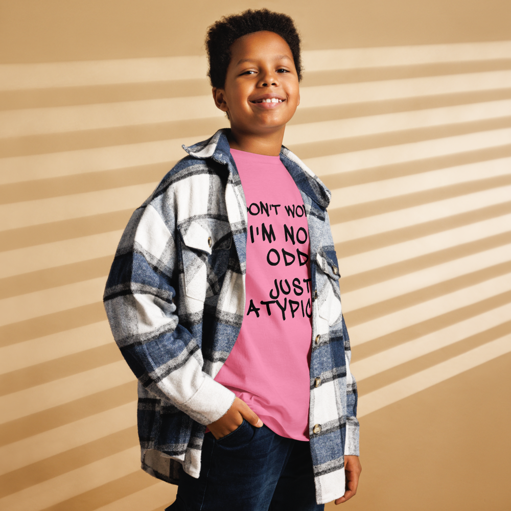 "Don't Worry I'm Not Odd Just Atypical" printed on a azalea youth classic tee worn by a male also wearing a jacket