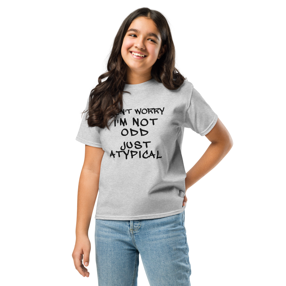"Don't Worry I'm Not Odd Just Atypical" printed on a sport grey youth classic tee worn by a female