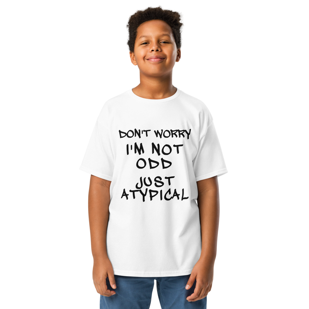 "Don't Worry I'm Not Odd Just Atypical" printed on a white youth classic tee worn by a male