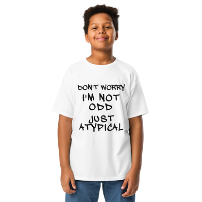 "Don't Worry I'm Not Odd Just Atypical" printed on a white youth classic tee worn by a male