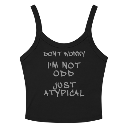 "Don't Worry I'm Not Odd Just Atypical" printed on a solid black blend women's micro-rib tanktop laying on a flat surface amongst sunglasses and shorts