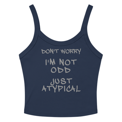 "Don't Worry I'm Not Odd Just Atypical" printed on a solid navy blend women's micro-rib tanktop laying on a flat surface amongst sunglasses and shorts