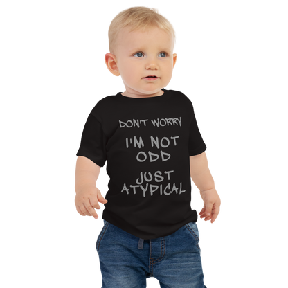 "Don't Worry I'm Not Odd Just Atypical" printed on a black baby jersey short sleeve tee worn by a male