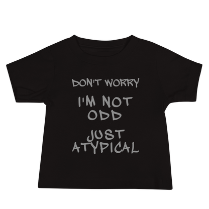 "Don't Worry I'm Not Odd Just Atypical" printed on a black baby jersey short sleeve tee laying on a flat surface