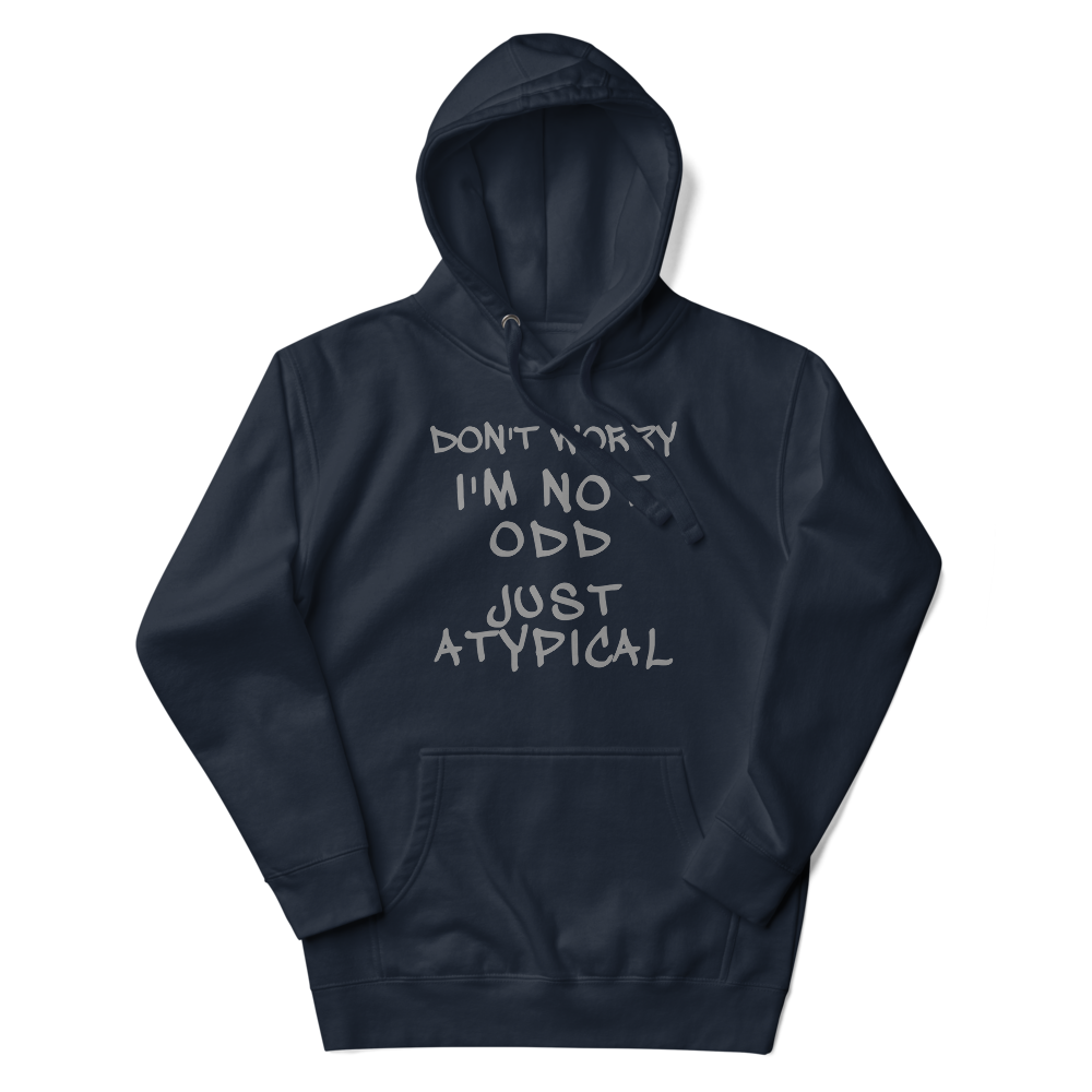 "Don't Worry I'm Not Odd Just Atypical" printed on a navy blazer unisex hoodie laying on a flat surface with the hood up