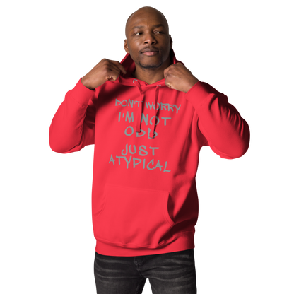"Don't Worry I'm Not Odd Just Atypical" printed on a team red unisex hoodie worn by a male