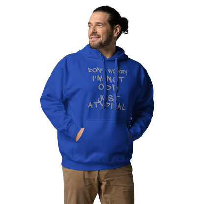 "Don't Worry I'm Not Odd Just Atypical" printed on a team royal unisex hoodie worn by a male