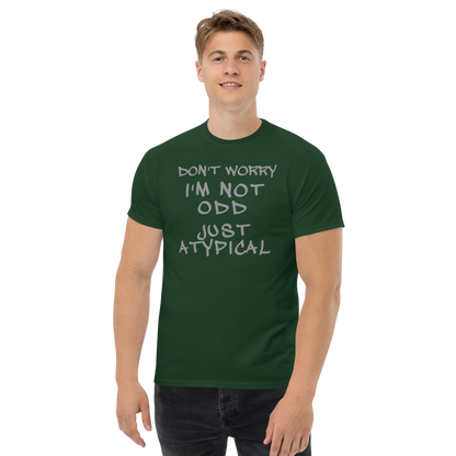 "Don't Worry I'm Not Odd Just Atypical" printed on a forest green unisex classic tee worn by a male
