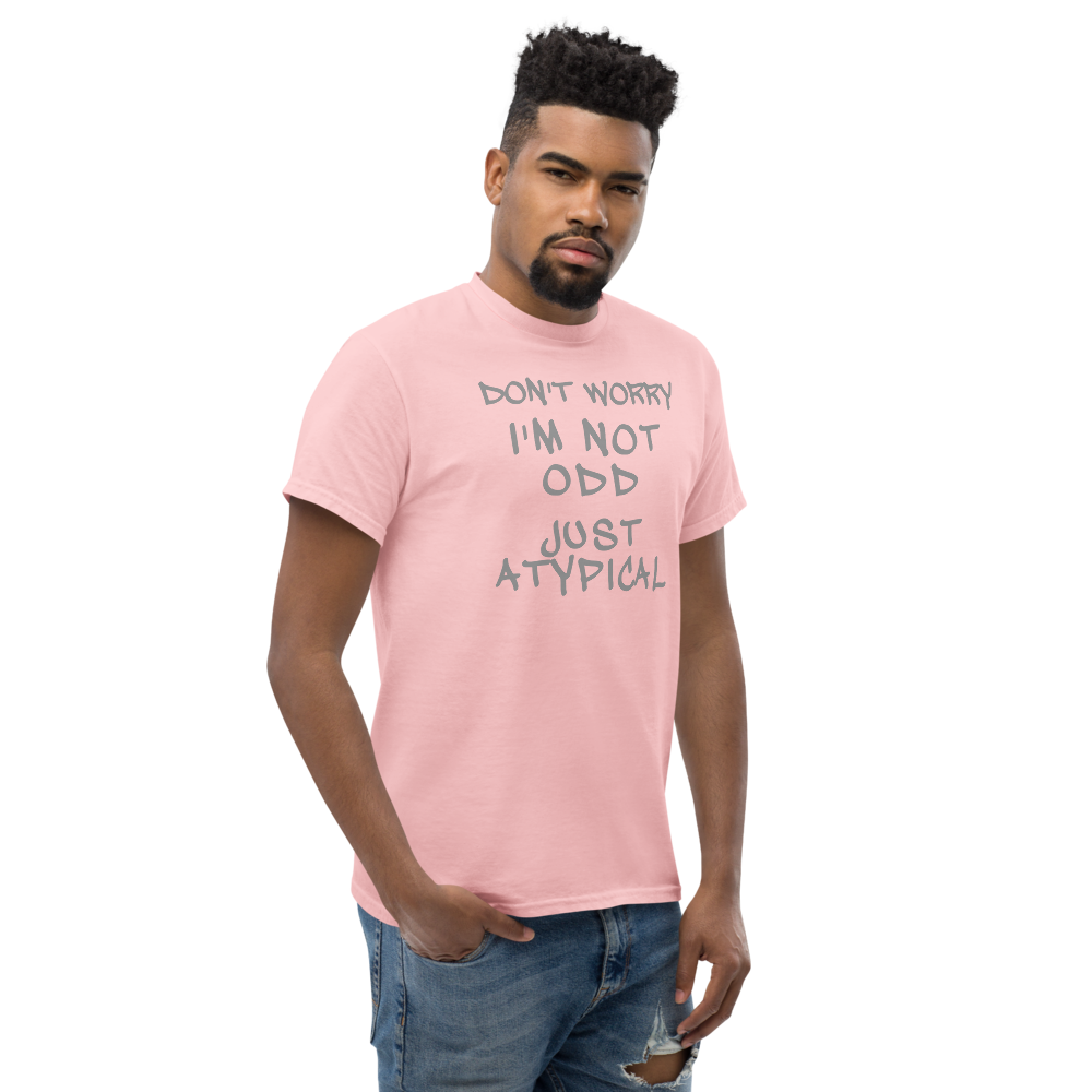 "Don't Worry I'm Not Odd Just Atypical" printed on a light pink unisex classic tee worn by a male