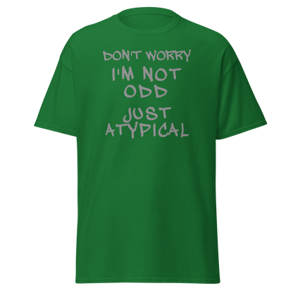 "Don't Worry I'm Not Odd Just Atypical" printed on a turf green on an invisible body