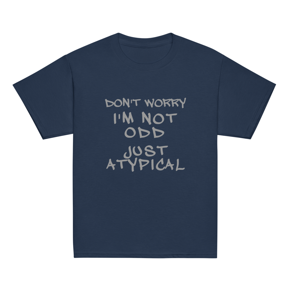 "Don't Worry I'm Not Odd Just Atypical" printed on a navy youth classic tee laying on a flat surface