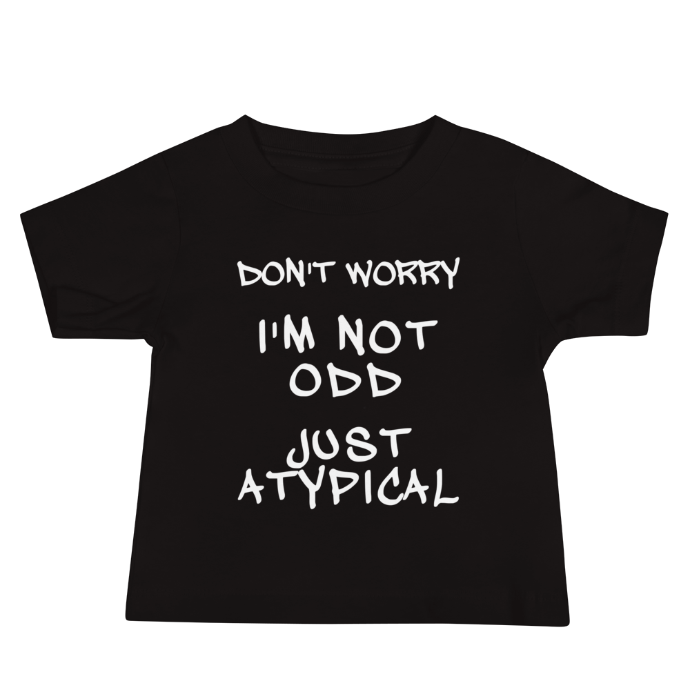 "Don't Worry I'm Not Odd Just Atypical" printed on a black baby jersey short sleeve tee laying on a flat surface