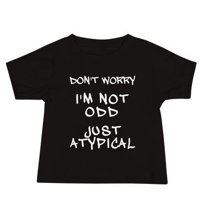 "Don't Worry I'm Not Odd Just Atypical" printed on a black baby jersey short sleeve tee laying on a flat surface