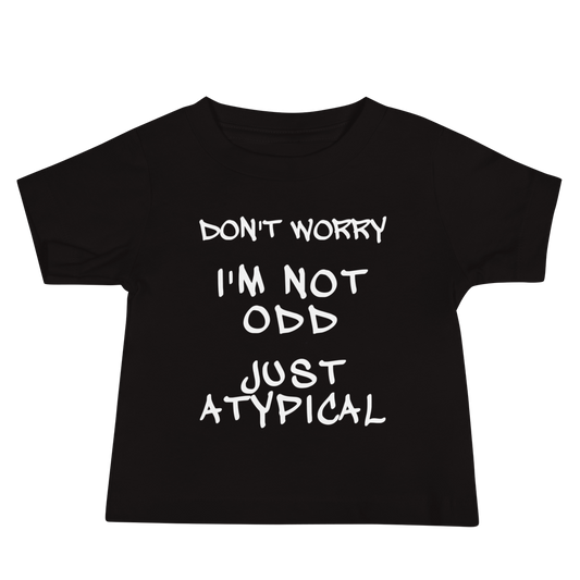 "Don't Worry I'm Not Odd Just Atypical" printed on a black baby jersey short sleeve tee laying on a flat surface