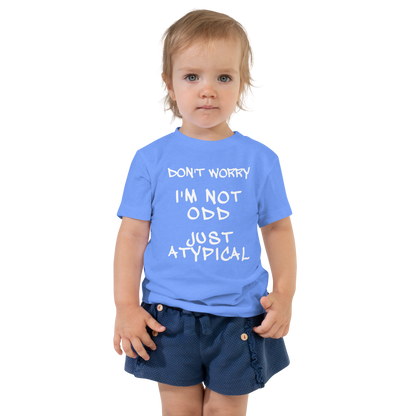"Don't Worry I'm Not Odd Just Atypical" printed on a heather columbia blue toddler short sleeve tee worn by a female