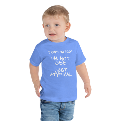 "Don't Worry I'm Not Odd Just Atypical" printed on a heather columbia blue toddler short sleeve tee worn by a male