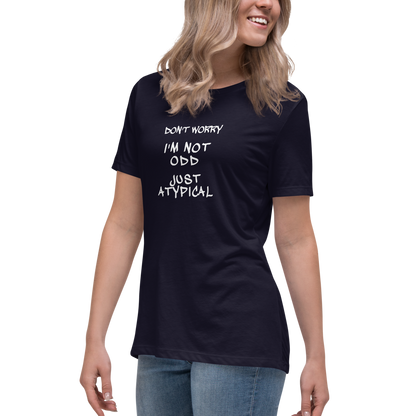 "Don't Worry I'm Not Odd Just Atypical" printed on a navy women's relaxed t-shirt worn by a female