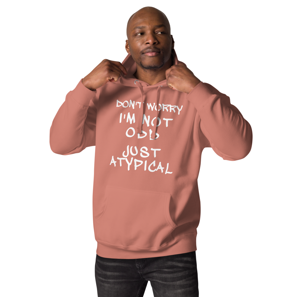 "Don't Worry I'm Not Odd Just Atypical" printed on a dusty rose unisex hoodie worn by a male