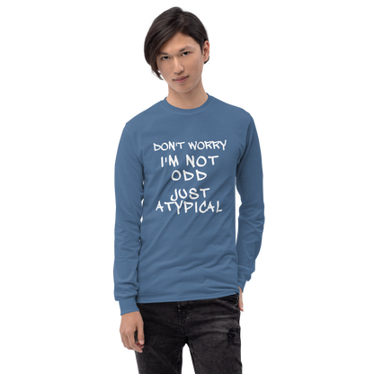 "Don't Worry I'm Not Odd Just Atypical" printed on a indigo blue men's long sleeve shirt worn by a male