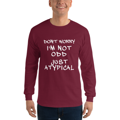 "Don't Worry I'm Not Odd Just Atypical" printed on a maroon men's long sleeve shirt worn by a male
