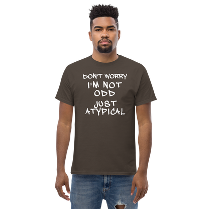 "Don't Worry I'm Not Odd Just Atypical" printed on a dark chocolate unisex classic tee worn by a male