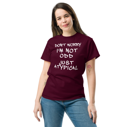 "Don't Worry I'm Not Odd Just Atypical" printed on a maroon unisex classic tee worn by a female