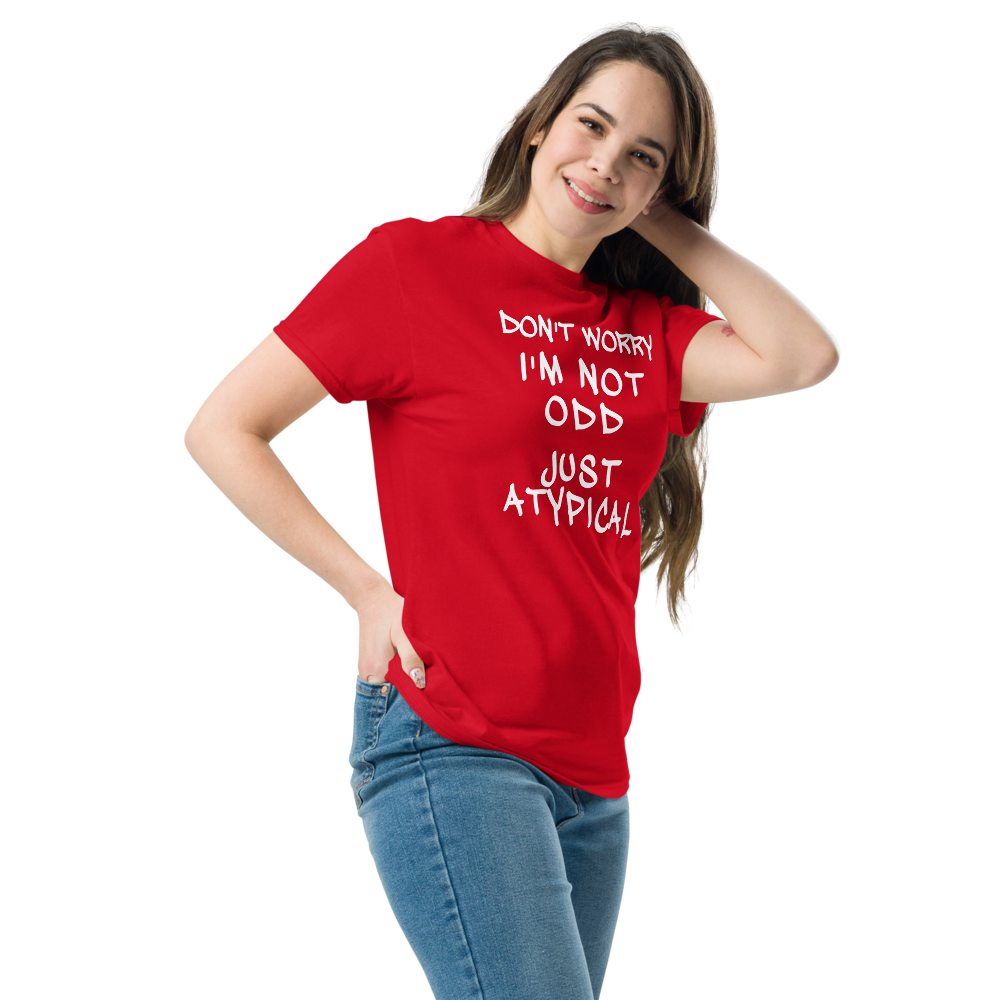 "Don't Worry I'm Not Odd Just Atypical" printed on a red unisex classic tee worn by a female