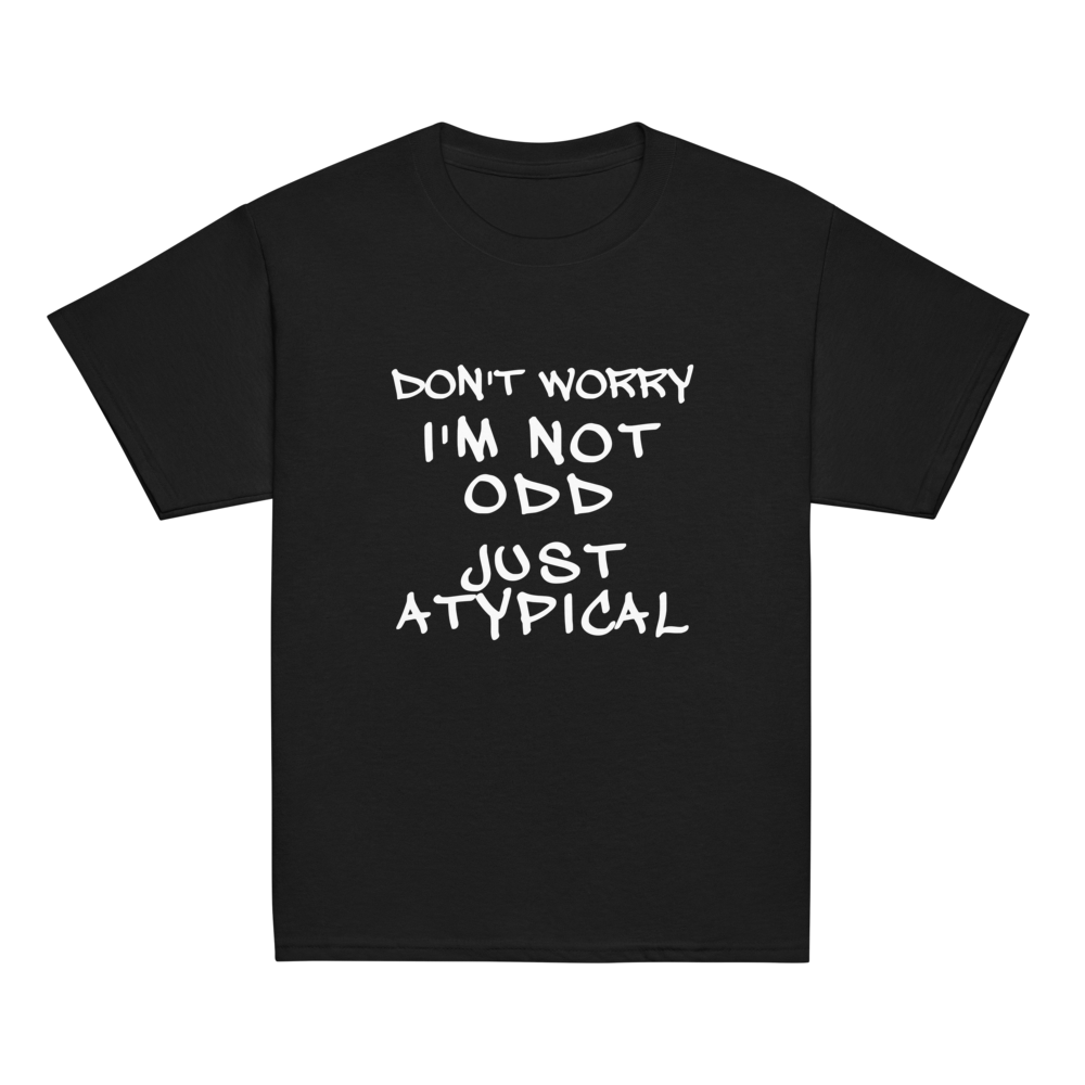 "Don't Worry I'm Not Odd Just Atypical" printed on a black youth classic tee laying on a flat surface