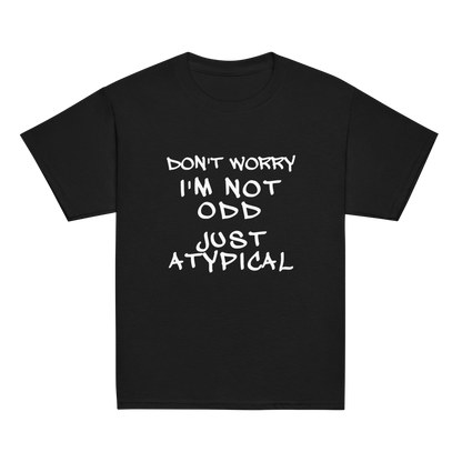 "Don't Worry I'm Not Odd Just Atypical" printed on a black youth classic tee laying on a flat surface