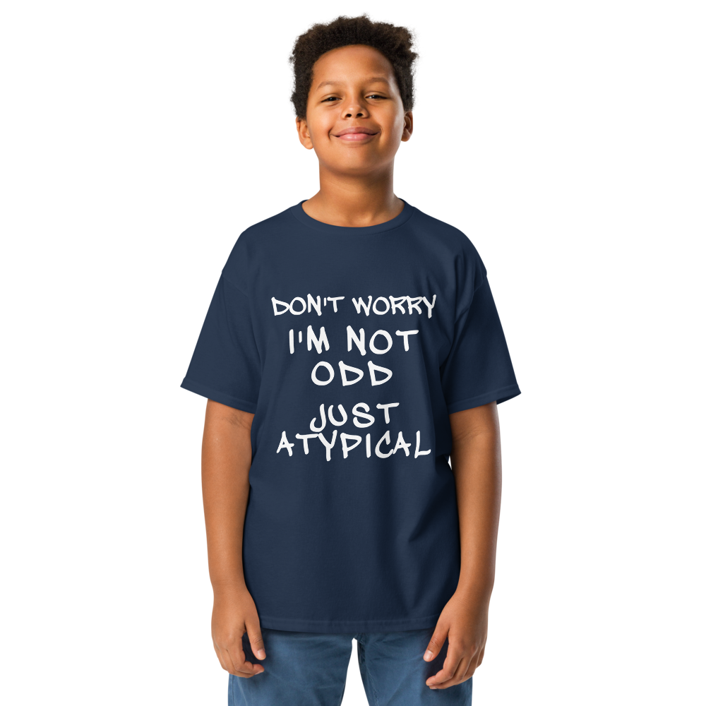 "Don't Worry I'm Not Odd Just Atypical" printed on a navy youth classic tee worn by a male