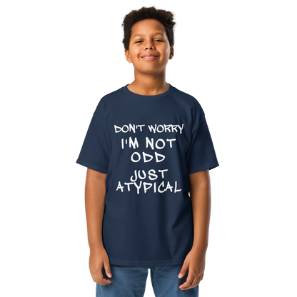 "Don't Worry I'm Not Odd Just Atypical" printed on a navy youth classic tee worn by a male