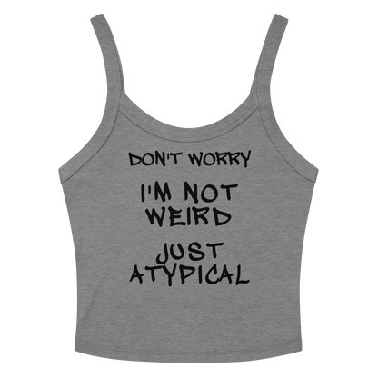"Don't Worry I'm Not Weird Just Atypical" printed on a athletic heather women's micro-rib tanktop laying on a flat surface amongst sunglasses and shorts