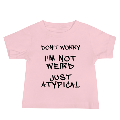 "Don't Worry I'm Not Weird Just Atypical" printed on a pink baby jersey short sleeve tee laying on a flat surface